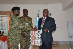 BRIG SSEMWANGA PRESENTING A GIFT TO A GUEST DURING 10TH AGM
